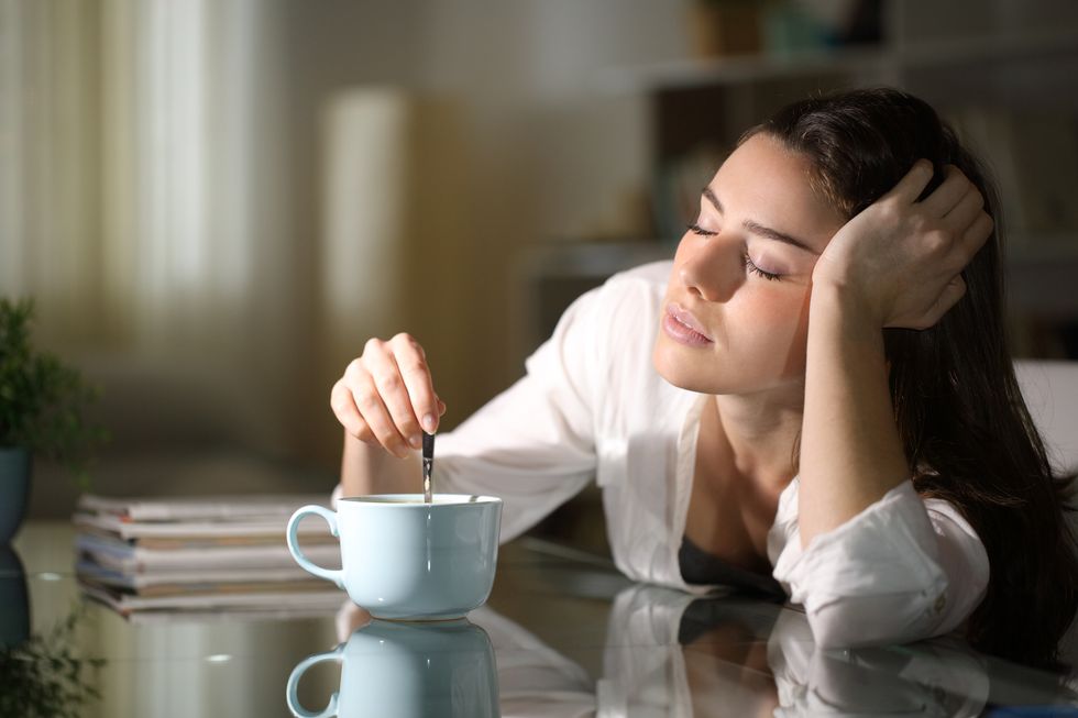 sleepy-woman-stirring-coffee-in-the-morning-royalty-free-image-1705896407.jpg