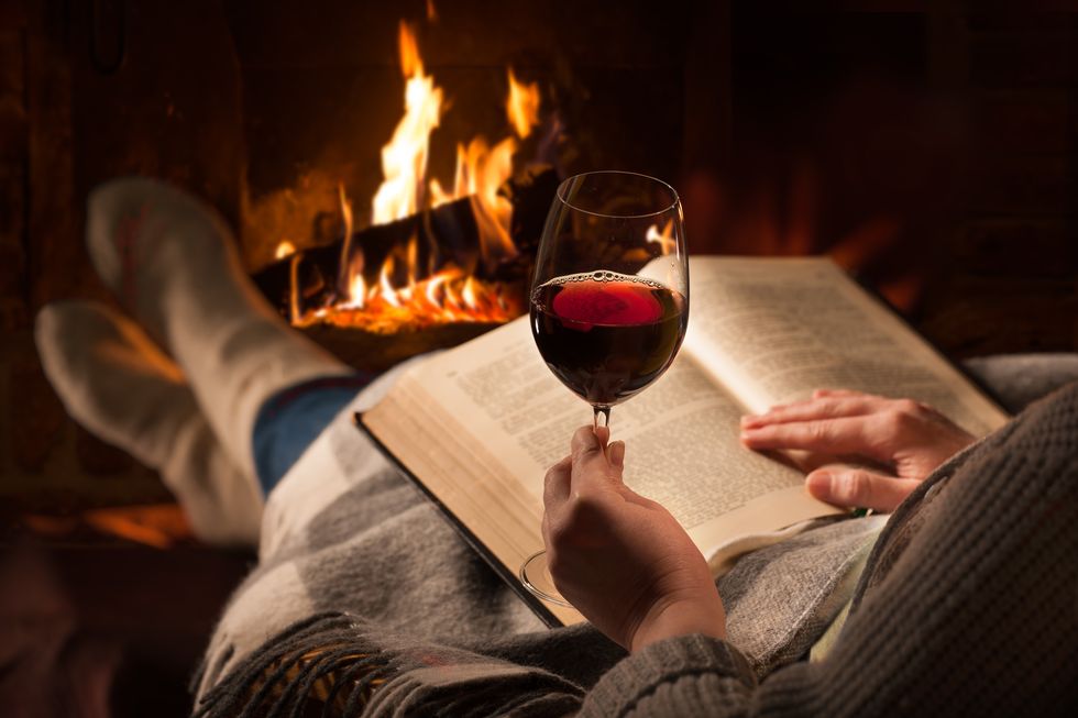 woman-reads-book-near-fireplace-royalty-free-image-1604024421.jpeg