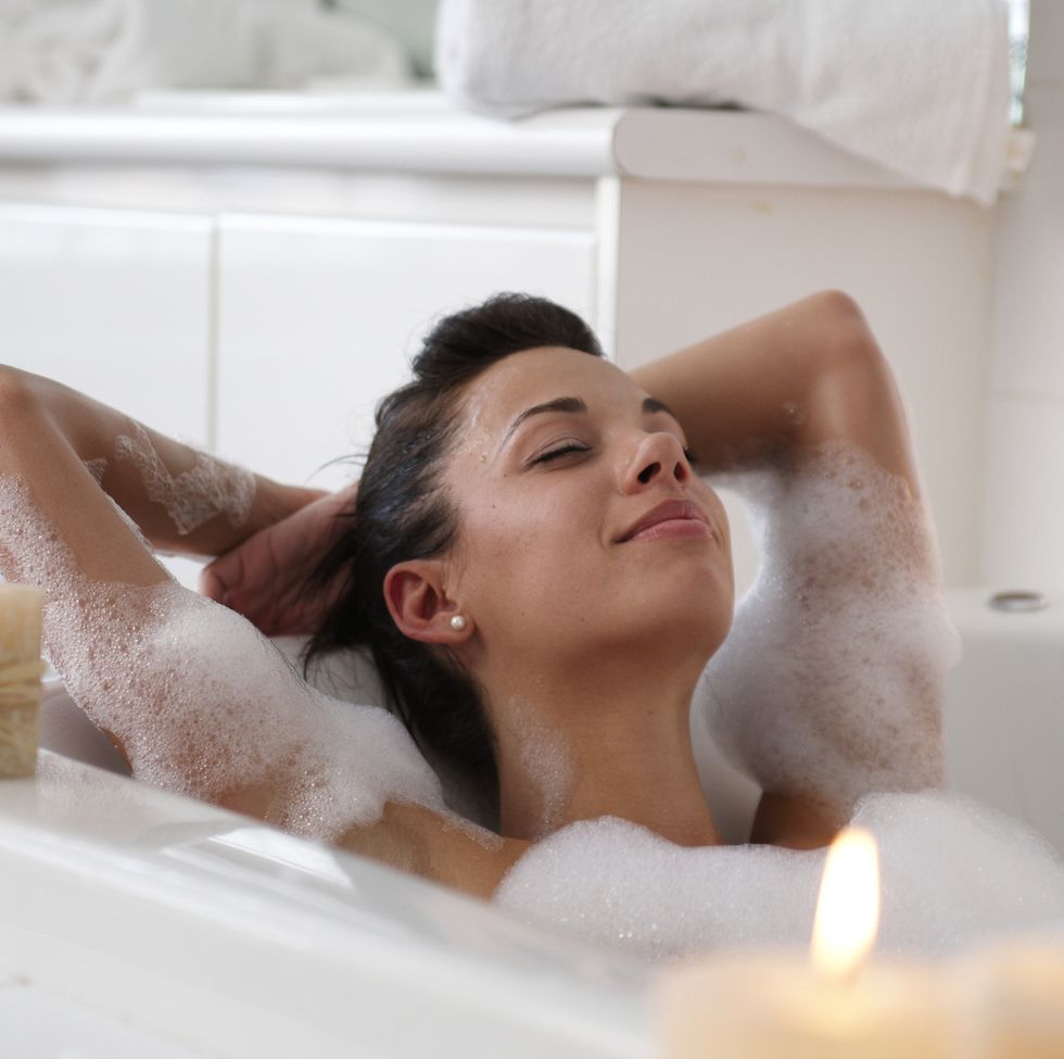 young-woman-in-bubble-bath-smiling-royalty-free-image-1705922188.jpg